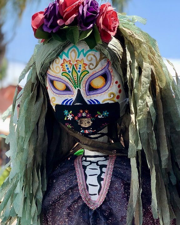 closeup of colorful parade float made of flowers at dia de los muertos in mexico city