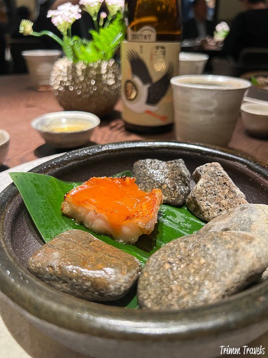 gray dish with orange fish and gray stones