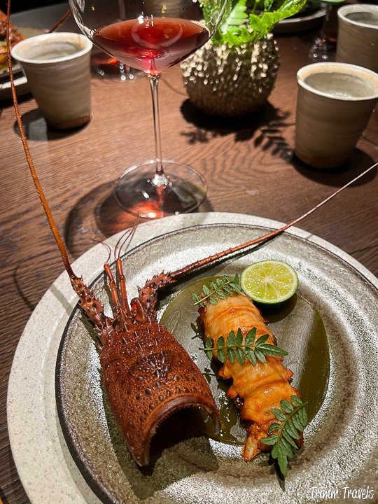 overview of lobster head shell with the meat to the right and a slice of lime