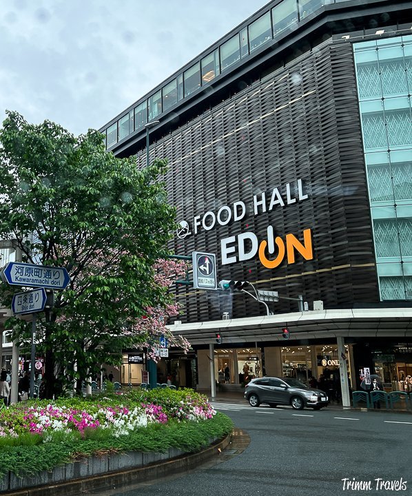 tall mult-story building with the english title of "food hall ed-on" in kyoto japan