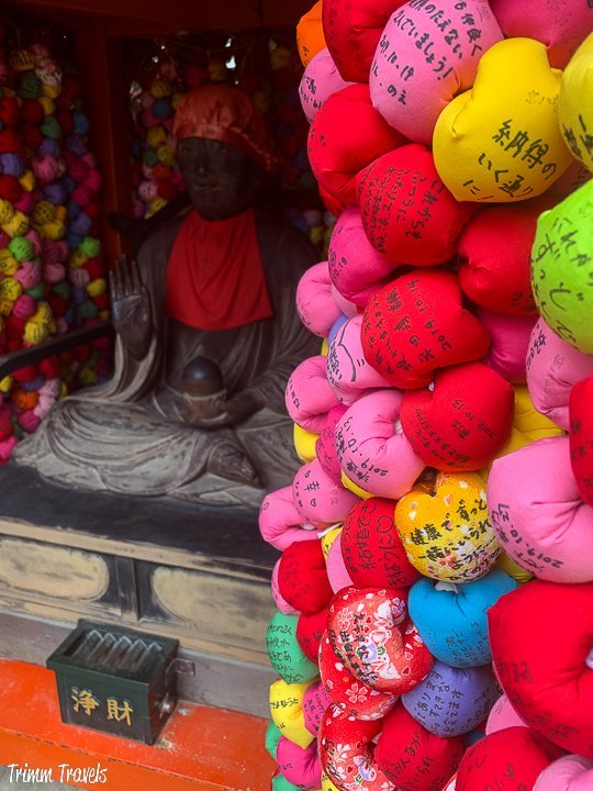 multiple colorful balls surrounding a compact temple in kyoto japan