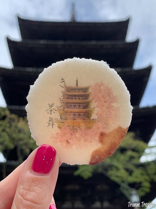 closeup of a cookie with a pagoda in front of the actual pagoda in the background