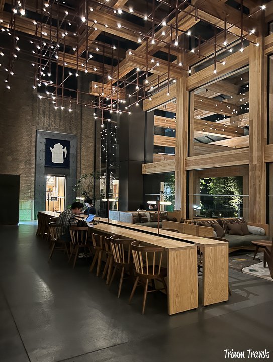white hanging lights above long beige counter work spaces at the ace hotel in kyoto japan